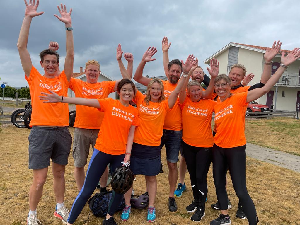 PTC Norther Europe team celebrating in orange tshirts.