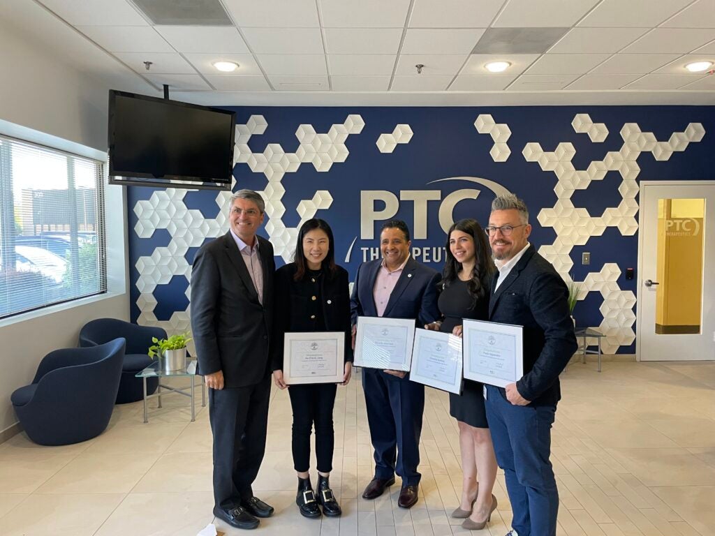 PTC's Emerging Leaders in the Warren New Jersey office lobby, holding certificates