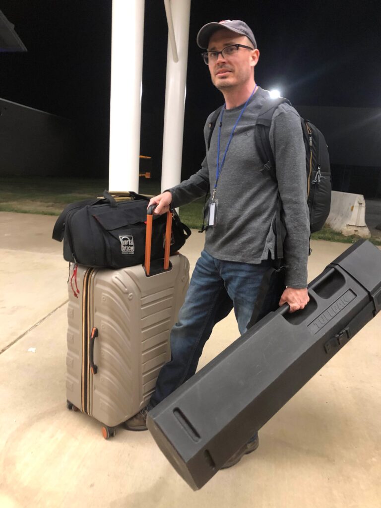 Image of Kevin Alexander, standing with suitcases